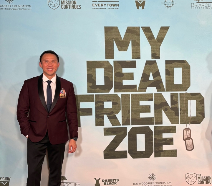 Thom Tran in front of a poster that reads My Dead Friend Zoe