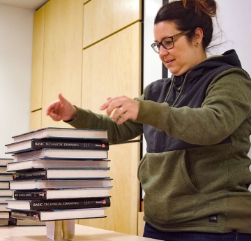 Teacher balancing books