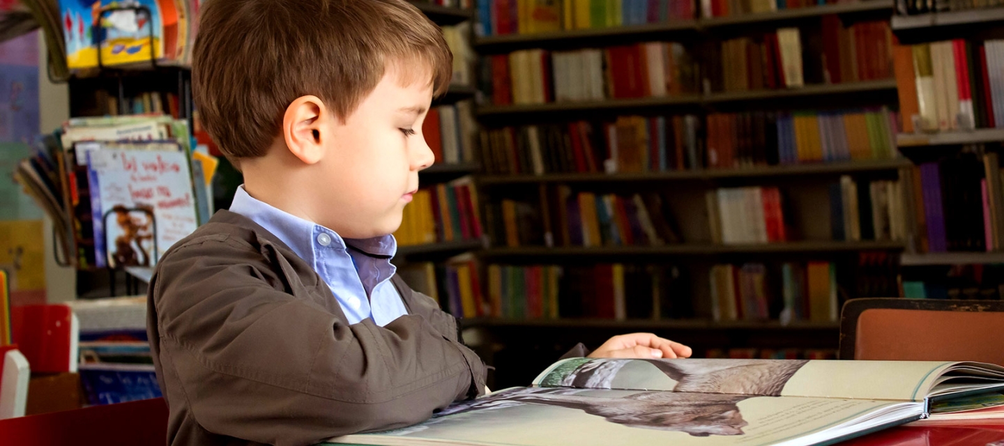 Child reading in a library